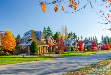 Luxury home with fall leaves and light dusting of snow