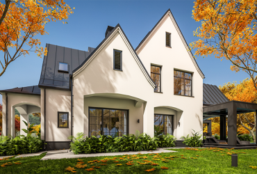 white and black modern Tudor style house on sunny autumn day